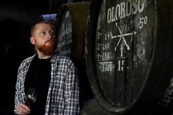 SMWS Head of Whisky Creation, Euan Campbell, standing by a sherry cask 