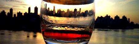 A city skyline seen through a whisky tumbler